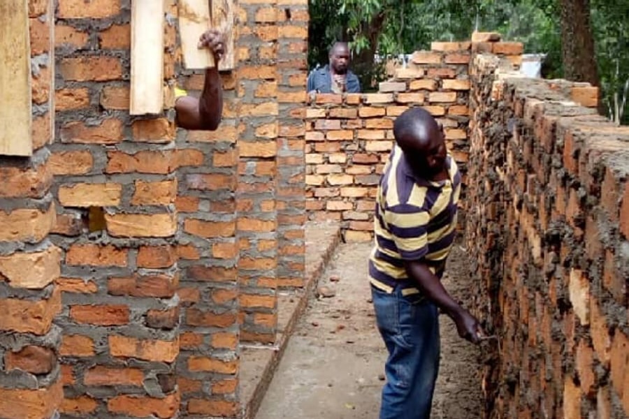 Workers construct the latrine block at Migongo Primary School, May 2018 — DROTY's first physical project.