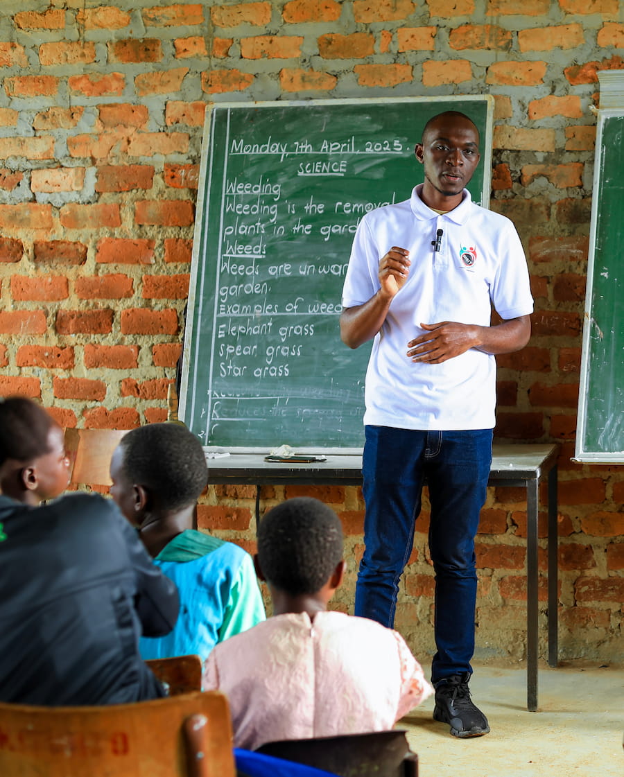 Timothy Ssessaazi, DROTY co-founder, leads a classroom session with students at a primary school in Kyotera.